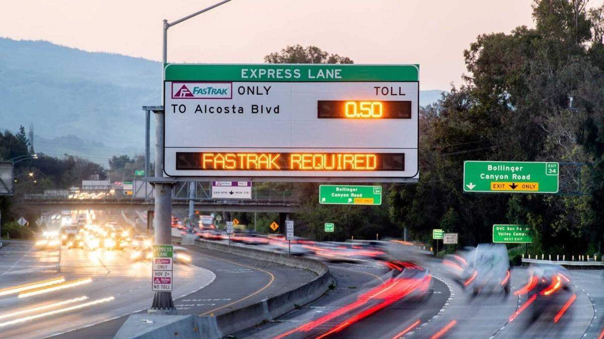 Traffic passes beneath a large electronic express lane sign over Interstate 680 at the Bollinger Canyon Road exit in San Ramon. Officials say toll data from this section of I-680 helped inform expectations for new congestion-based express lanes opening Dec. 16 on Interstate 80 between Fairfield and Vacaville.