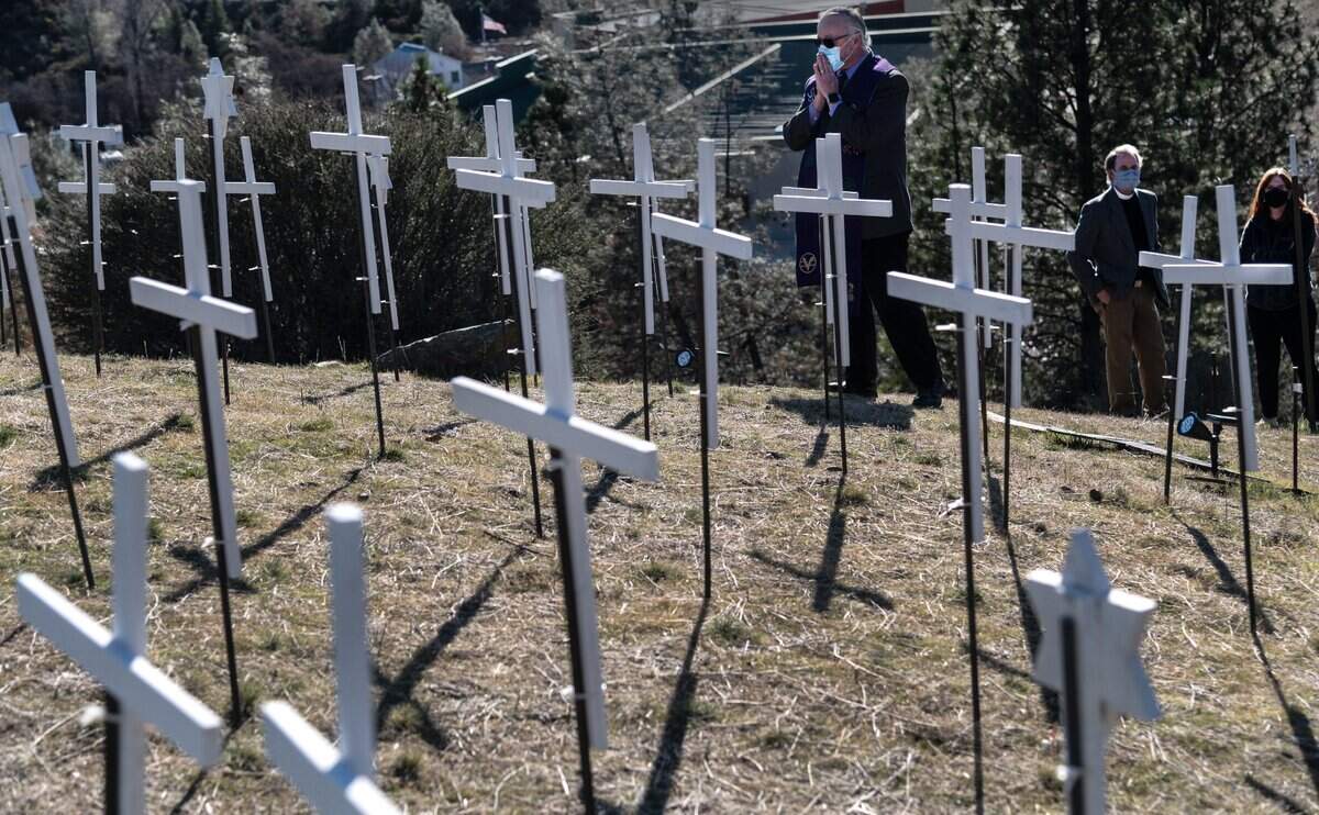 Rev. Rafe Ellis, from the Center for Spiritual Living, takes a moment to pray on Tuesday, Jan. 19, 2021, after speaking at a memorial to honor the 73 lives lost to COVID-19 in Nevada County.