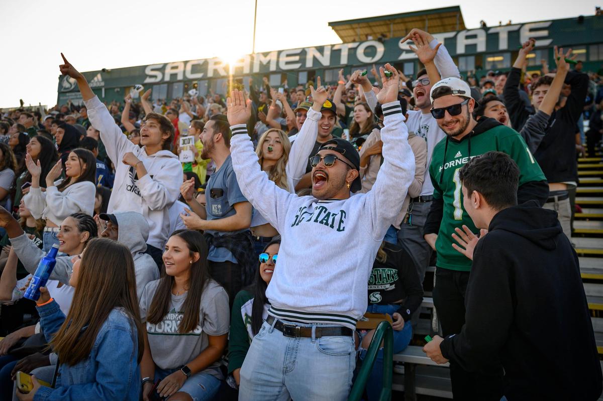 Sacramento State senior Harlow Johnson cheers the Hornets Causeway Classic against UC Davis at Hornet Stadium in 2019. Sacramento State on Thursday announced plans to build a new, 25,000-seat football stadium by 2028.