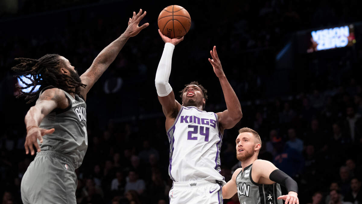 Kings guard Buddy Hield lofts a shot in front of Brooklyn’s DeAndre Jordan and guard Dzanan Musa. Go to sacbee.com for complete coverage of Friday night’s game between the Nets and Kings.
