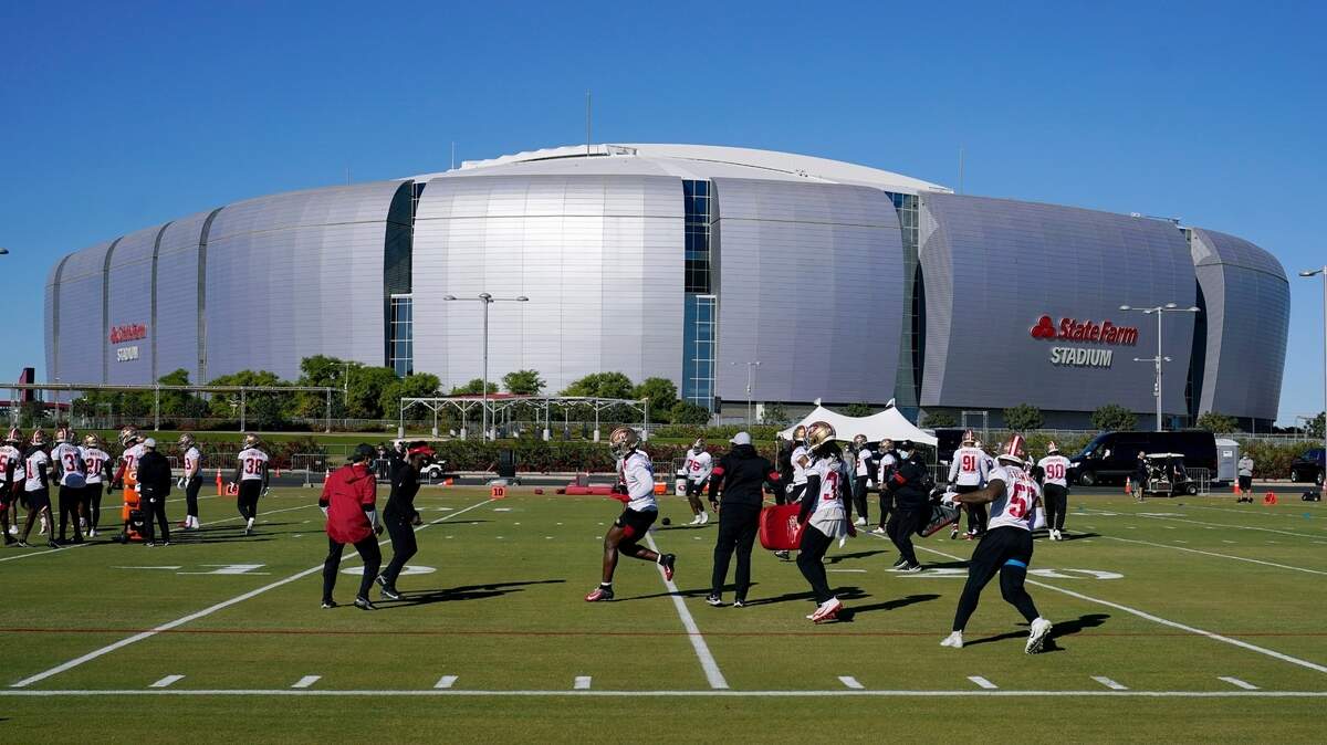 The San Francisco 49ers practice in front of State Farm Stadium, home of the Arizona Cardinals, on Thursday.