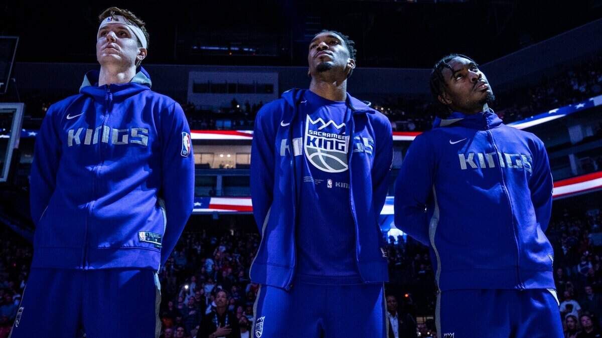 Sacramento Kings guard Kevin Huerter, left, and teammates Malik Monk, center, and Davion Mitchell,right, stand for the national anthem before the game against the Chicago Bulls on Sunday, Dec. 4, 2022, at Golden 1 Center in Sacramento.