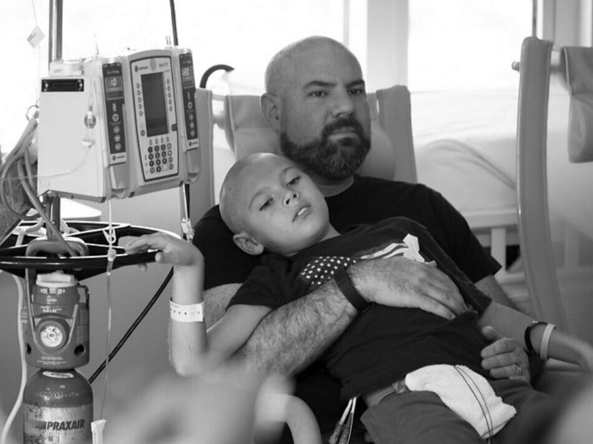Rick Rummelhart holds his son Sawyer during a hospital visit. Sawyer died in 2015 of Burkitt lymphoma, yet his memory and spirit greet customers every day at Sawyer’s Sweet Spot candy stores in Woodland and Yuba City.