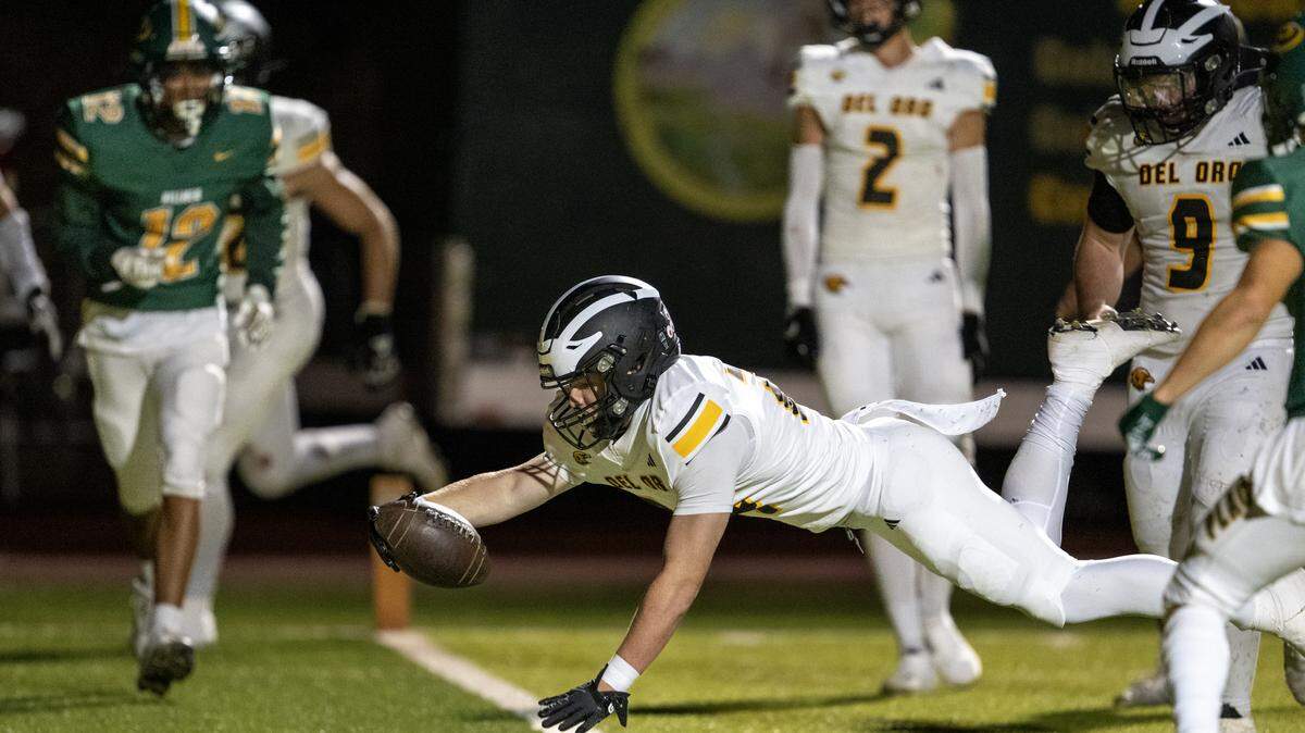 The Del Oro Golden Eagles' Sam Lawrence (24) dives into the end zone for a touchdown against the Placer Hillman In the second half on Friday in Auburn.