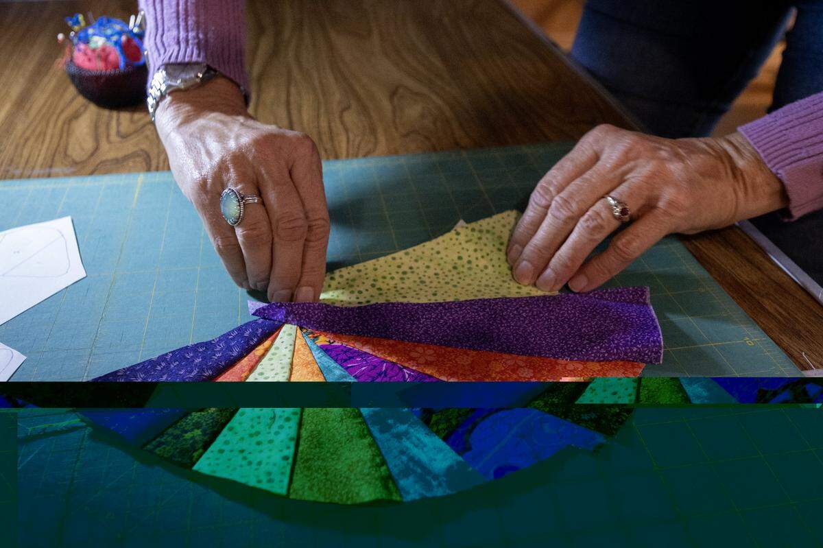 Jessa Kay Cruz arranges fabric pieces before sewing them into a quilt on Nov. 7 in Sacramento.