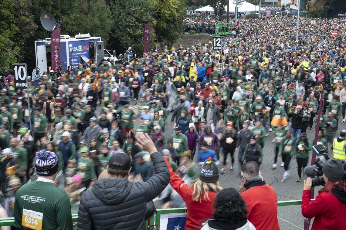 Runners in the 5k race start running during the Run to Feed the Hungry in Sacramento on Thursday, Nov. 27, 2025.