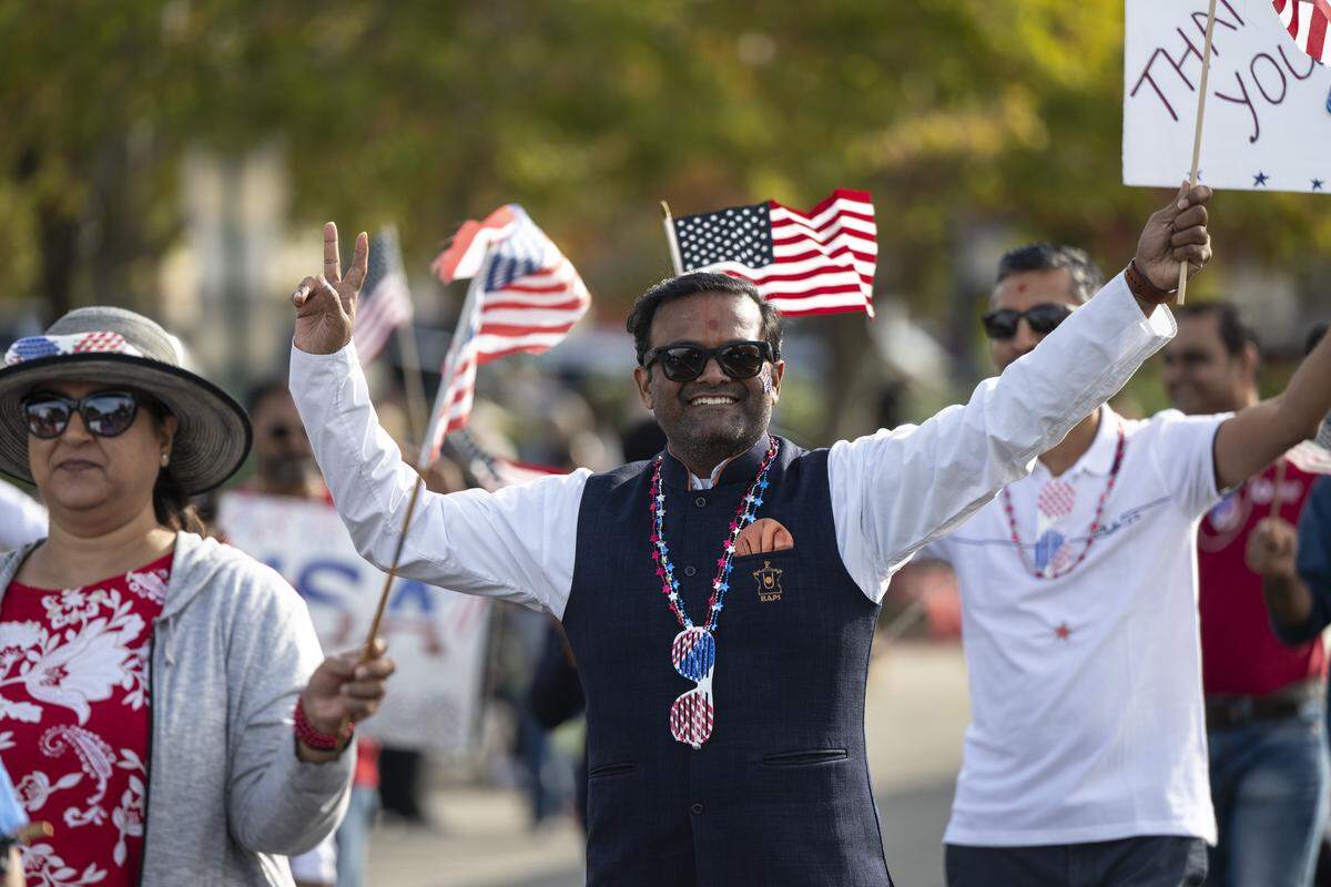 Parade participants march down East Bidwell Street during a Veterans Day parade in Folsom on Tuesday, Nov. 11, 2025.