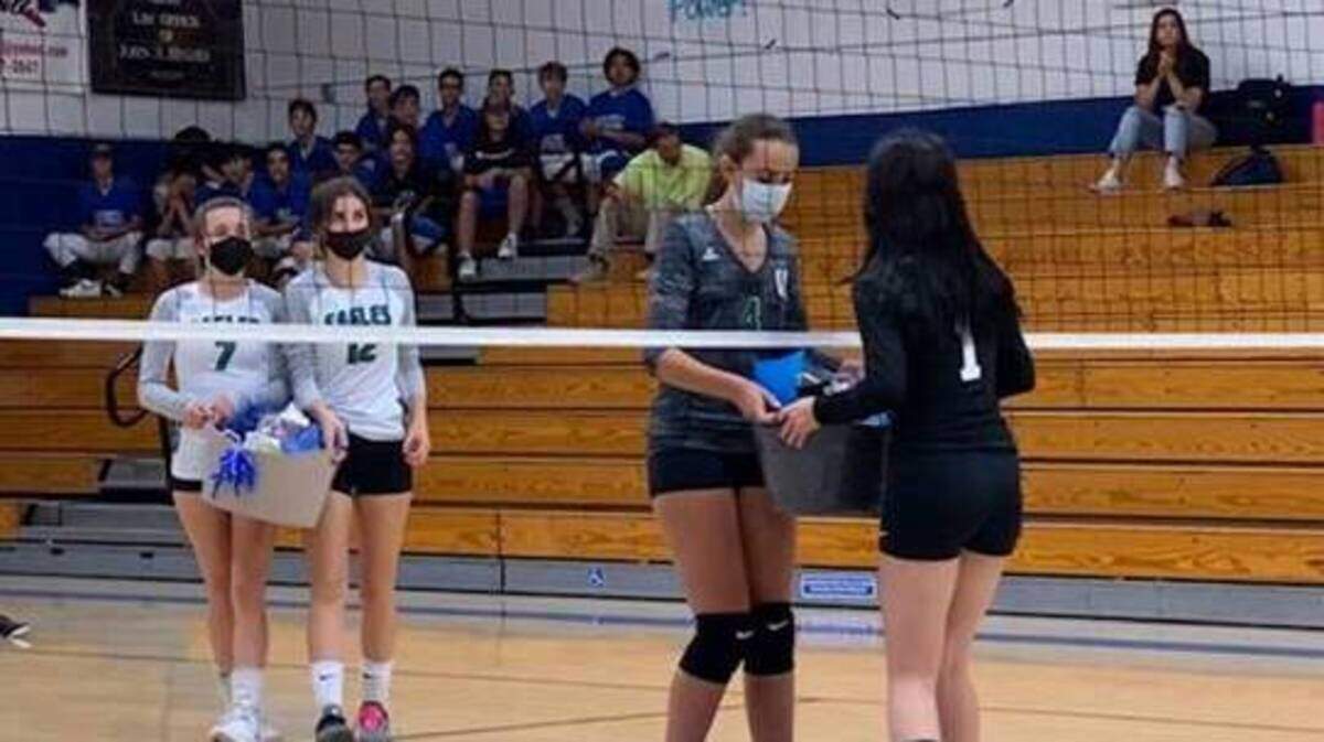 El Camino players hand a basket filled with essentials to an El Dorado volleyball player prior to Tuesday night’s game in Placerville.