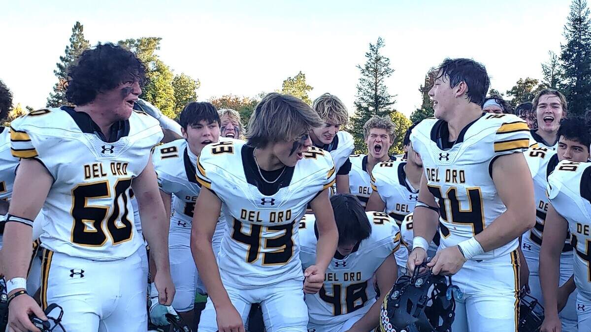 Del Oro High School football players celebrate after beating Jesuit in triple overtime in a Sac-Joaquin Section Division II playoff game Saturday in Carmichael.