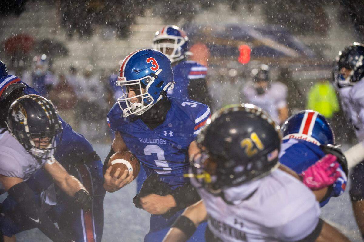 Folsom Bulldogs quarterback Ryder Lyons (3) runs through the Inderkum Tigers’ defense in the first half of the CIF Sac-Joaquin Section football playoffs semifinal Friday in Folsom.