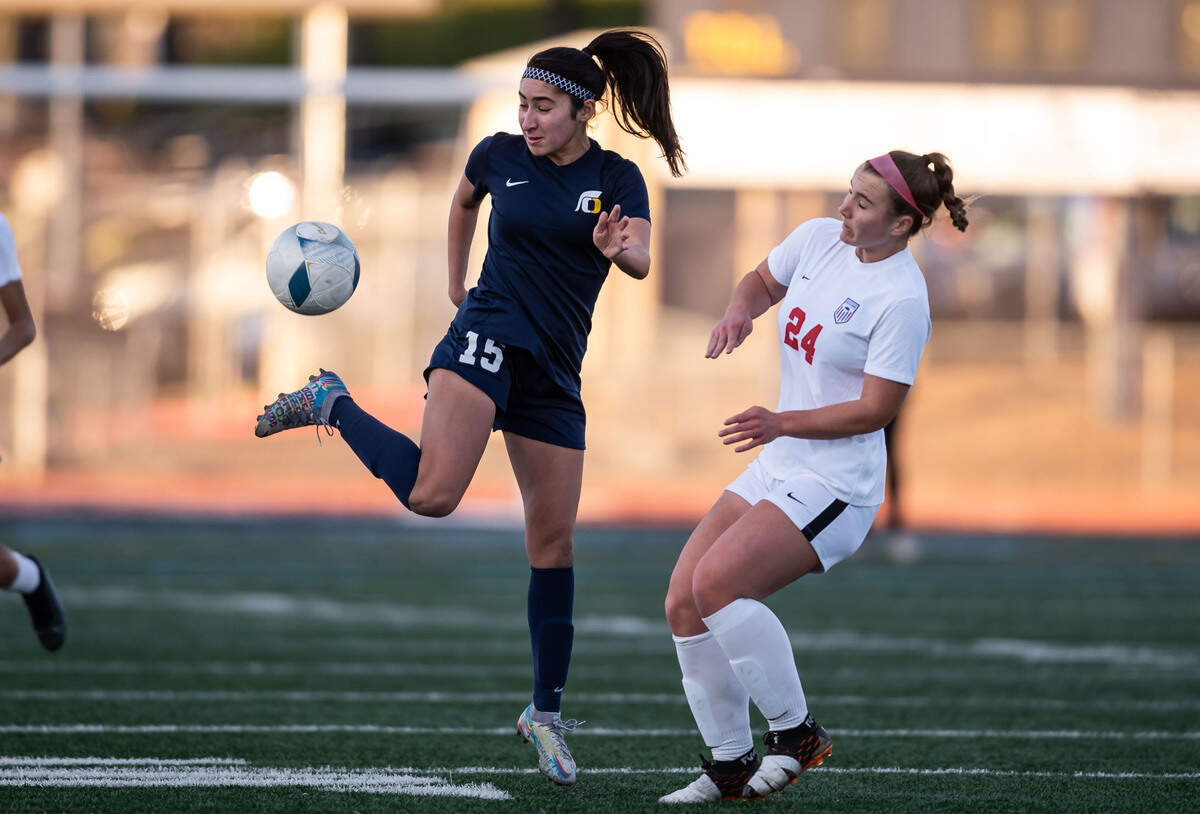 Oak Ridge Trojans’ Sophia Moness (15), left, side kicks the ball as Buchanan Bears’ Rylie Chaney (24) defends during the first half of the high school girls soccer CIF NorCal Division I championship game Saturday, March 5, 2022, at Oak Ridge High School in El Dorado Hills. Oak Ridge came from behind to tie Buchanan 2-2, survived overtime then won after penalty kicks.
