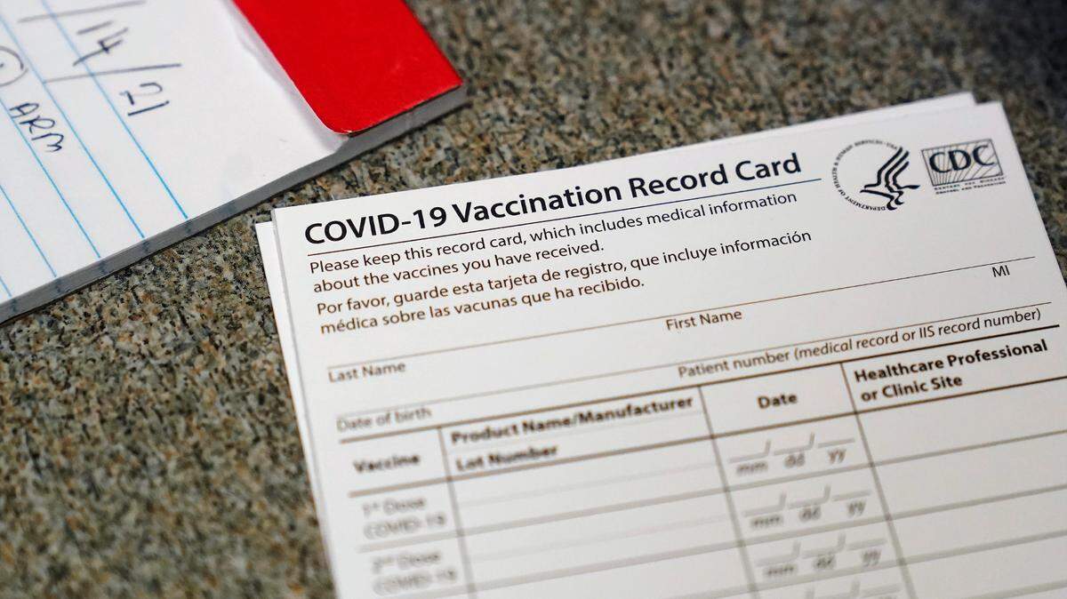 FILE - In this Dec. 24, 2020, file photo, a COVID-19 vaccination record card is shown at Seton Medical Center in Daly City, Calif. The alcohol license was suspended Nov. 1, 2021, at the Old Corner Saloon where fake COVID vaccination cards were sold in Clements, California.