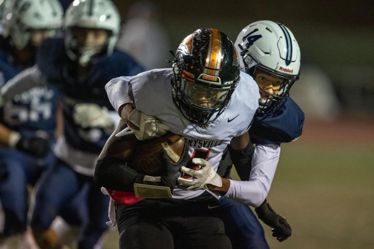 The Marysville Indians’ Dennis Syders (4) is tackled by Oakmont Vikings defensive back Jayden Beasley (14) after a short gain In the first half on Friday, Oct. 25, 2024 in Roseville.