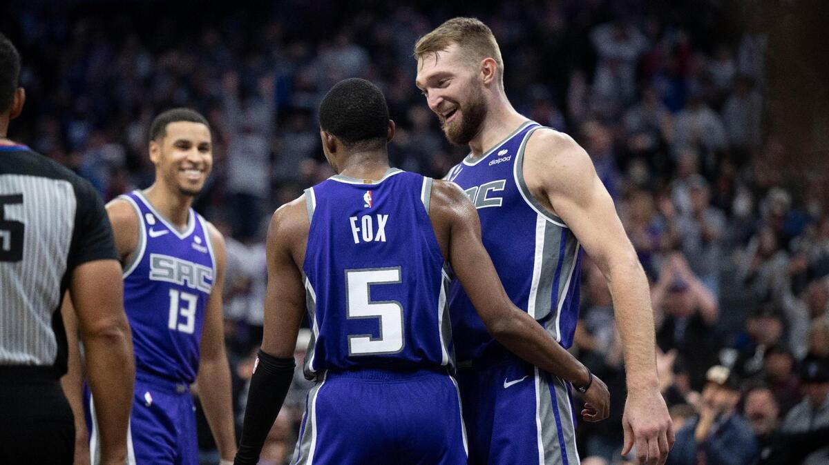 Sacramento Kings forward Domantas Sabonis (10) congratulates teammate De’Aaron Fox (5) after he dunked against the Utah Jazz on Friday, Dec. 30, 2022 during an NBA basketball game at Golden 1 Center in Sacramento.