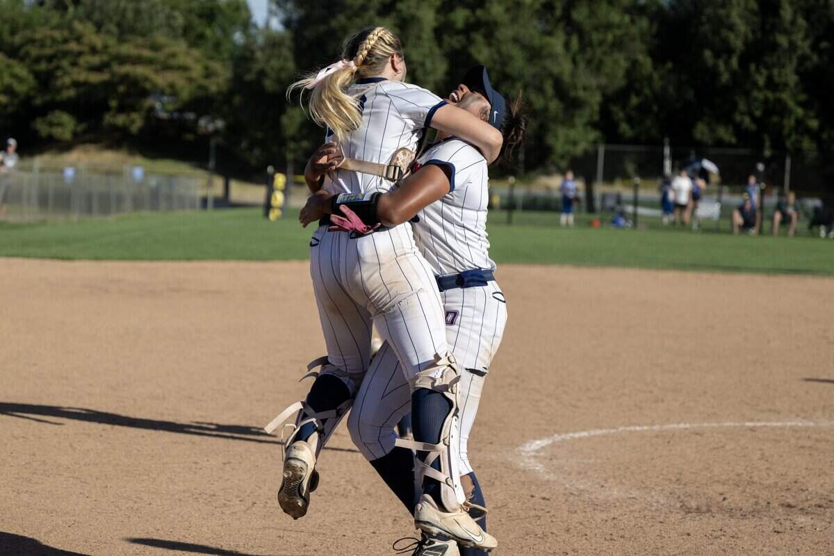 Destiny Christian Academy Lions pitcher Ayla Tuua and catcher KK Fulmer embrace after the final out against the Whitney Wildcats to win the CIF NorCal Division I championship softball game on Saturday in Rosemont.