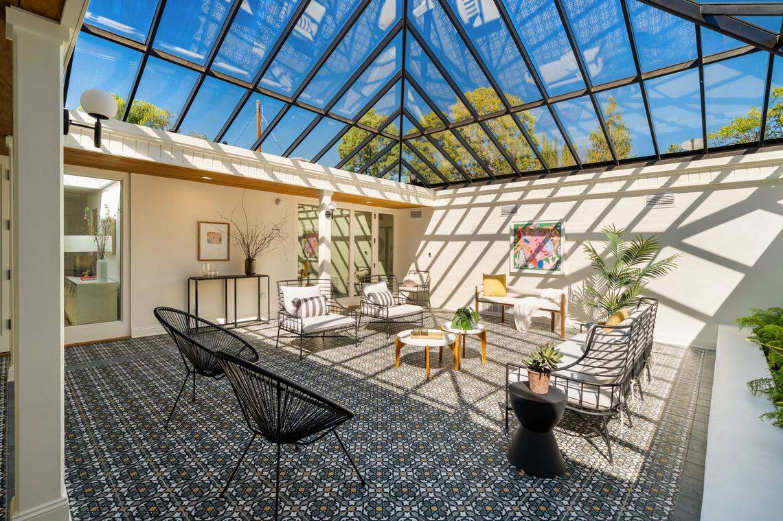 At the heart of the Cracker Jack House in Pasadena, a sunlit atrium anchors the three-bedroom, three-bathroom main residence.