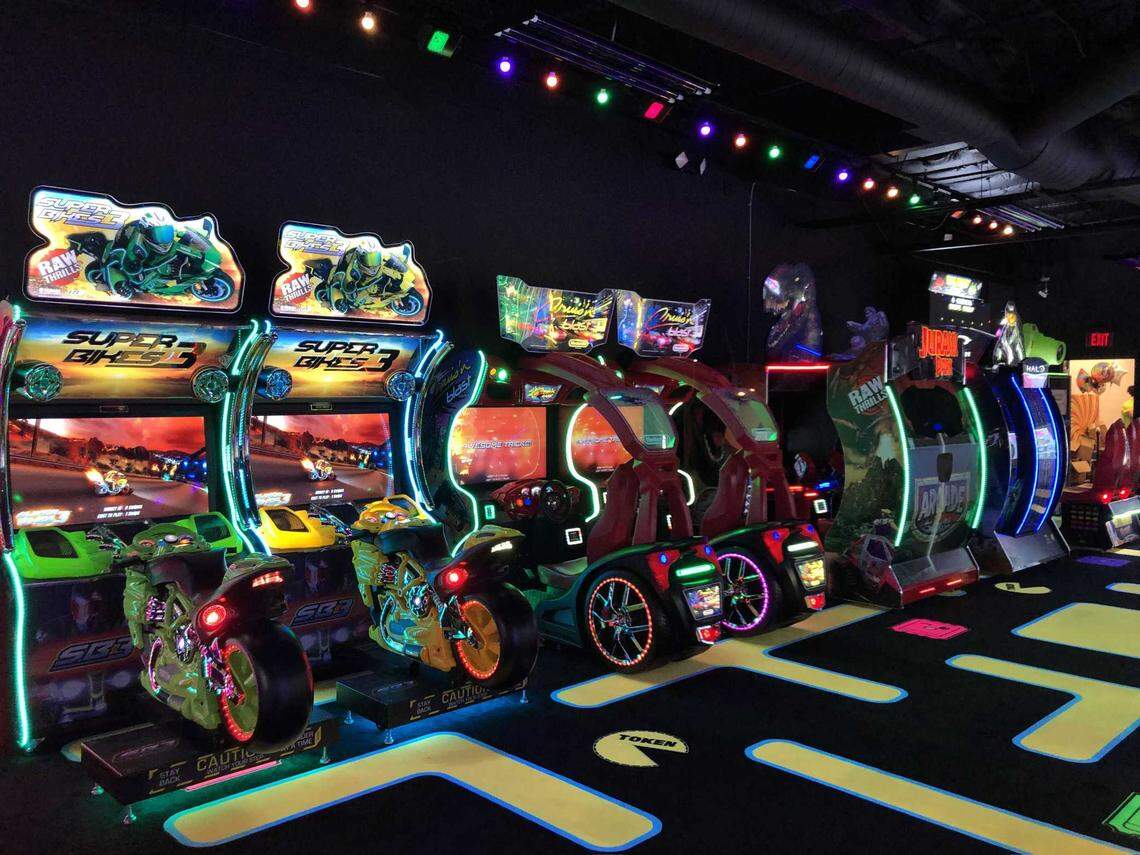 Fun Zone Arcade’s row of video-related games, photographed on Jan. 5, 2023, includes two motorcycle racers, two car racers and two first-person shooter games themed for Jurassic Park and Halo. Representatives for Fun Zone Arcade said they plan on doing something bigger at Palladio in the next year or two.