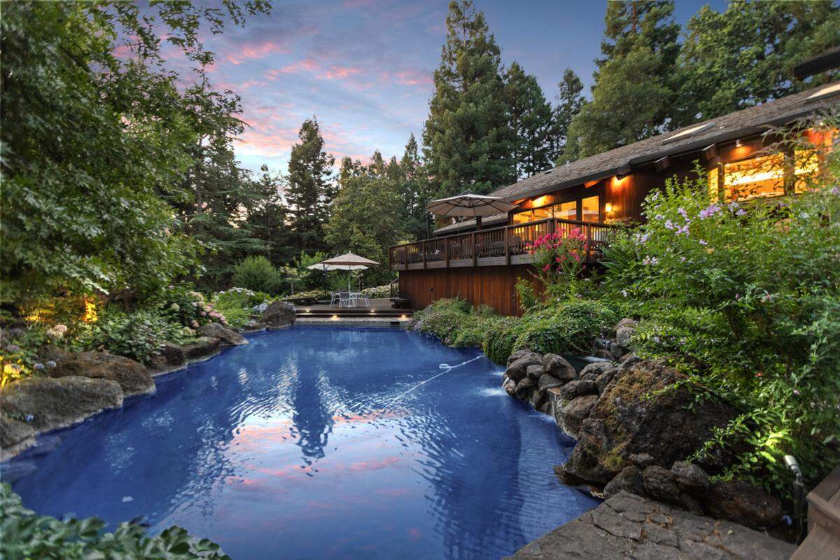 The 2.39 acres of lush grounds at 5312 Retreat Way include a pool, crystal clear pond, meandering trails and a sports court.