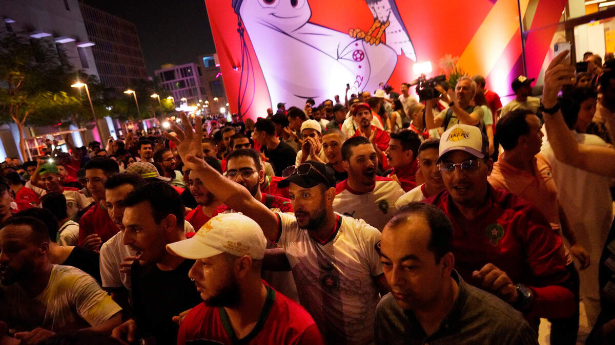 Moroccan fans cheer as they march through in Doha, Qatar, Friday, Nov. 18, 2022. Fans poured into Qatar on Friday ahead of the Middle East’s first World Cup as Doha ordered beers not to be poured out at stadiums during the tournament — a last-minute surprise largely welcomed by the country’s conservative Muslims and shrugged off by giddy fans. (AP Photo/Jon Gambrell)