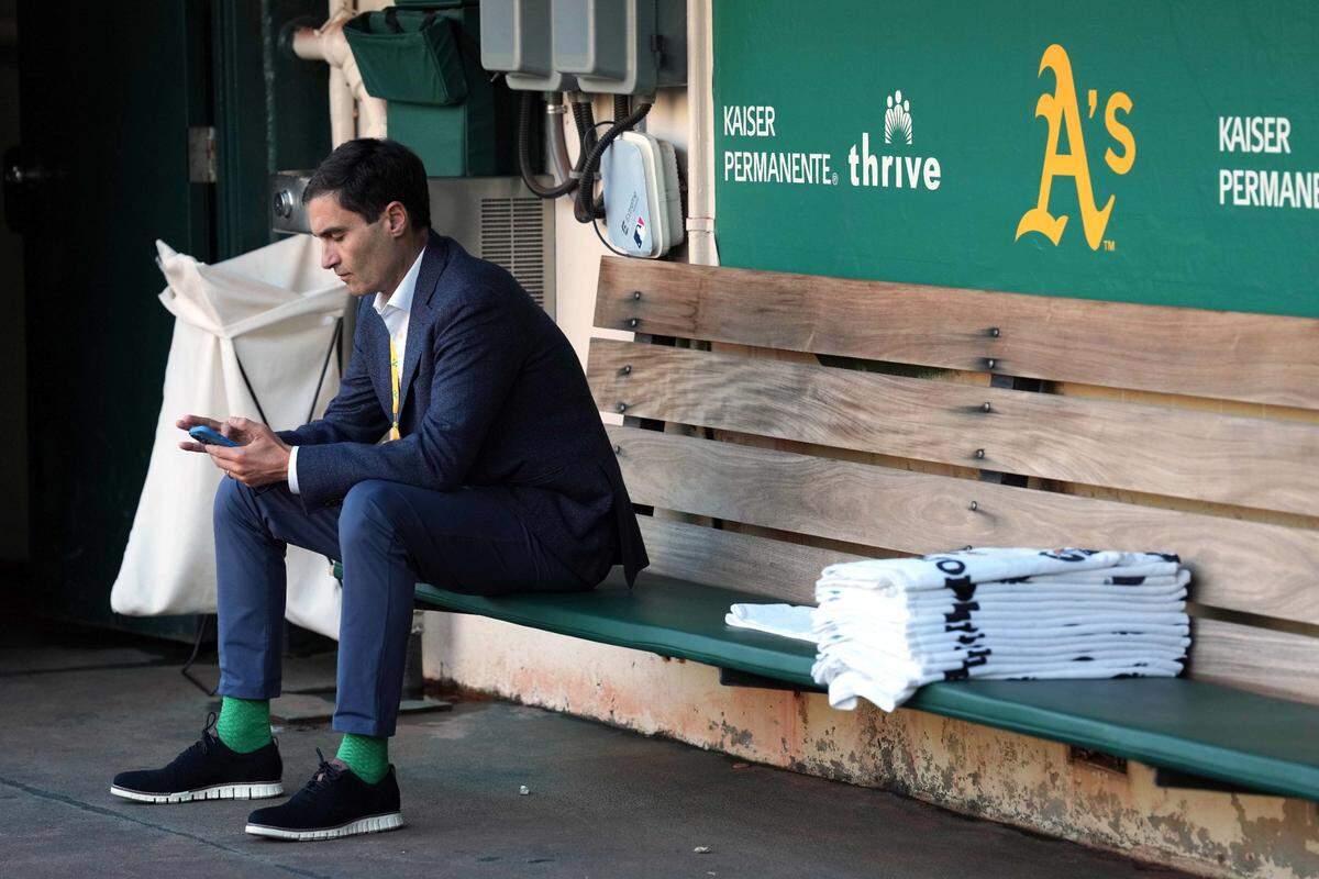 Sep 23, 2022; Oakland, California, USA; Oakland Athletics president Dave Kaval sits in the dugout before the game against the New York Mets at RingCentral Coliseum. Mandatory Credit: Darren Yamashita-USA TODAY Sports