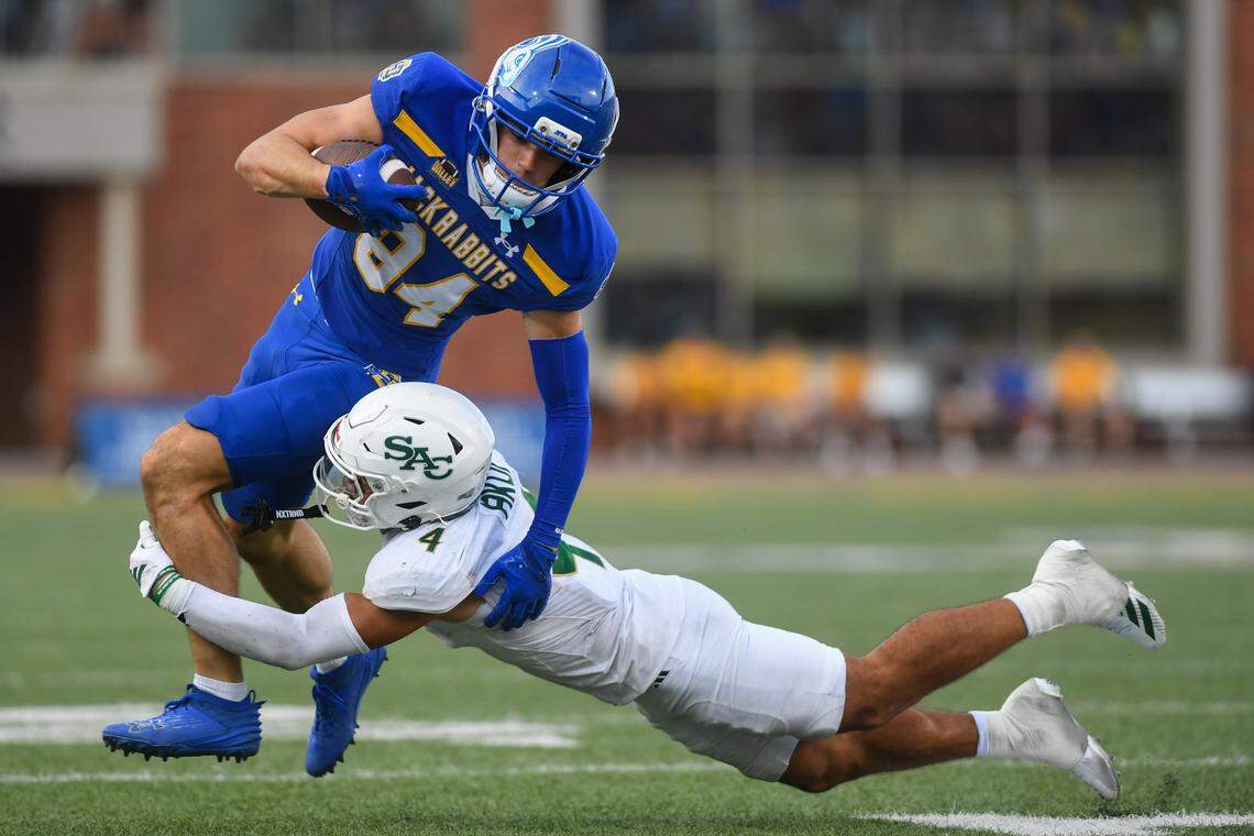 South Dakota State Jackrabbits wide receiver Alex Bullock (84) runs with the ball while evading Sacramento State Hornets running back Damian Henderson II (4) on Saturday, Aug. 30, 2025, at Dana J. Dykhouse Stadium in Brookings, South Dakota.