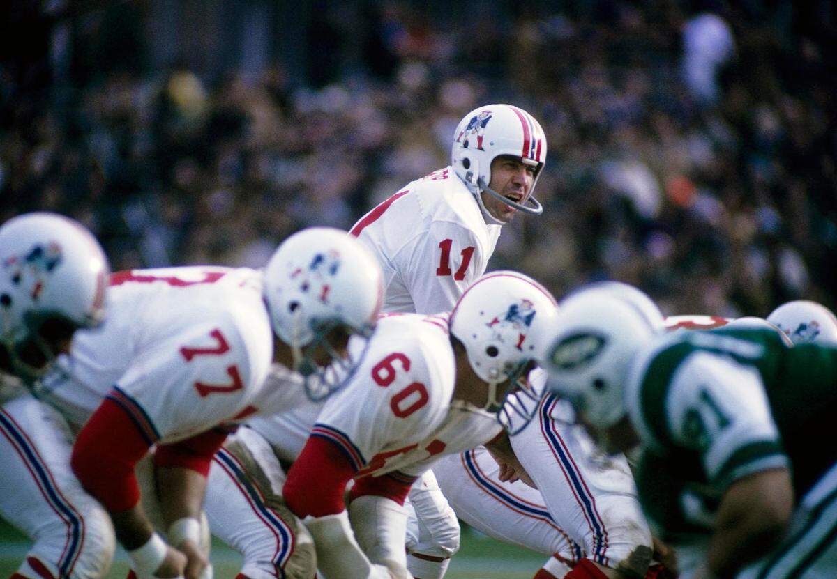 Boston Patriots quarterback Joe Kapp (11) at the line of scrimmage against the New York Jets at Harvard Stadium on Nov. 22, 1970, in Boston, Massachusetts.