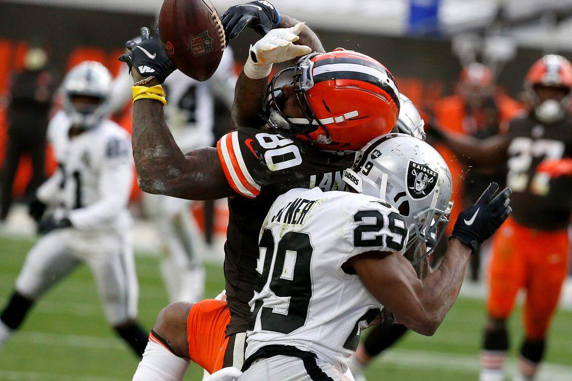 Raiders safety Lamarcus Joyner hits Cleveland wide receiver Jarvis Landry to break up a pass.
