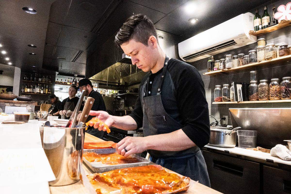 Line cook Erik Fox prepares fish for the green curry ceviche at Localis in midtown Sacramento on Dec. 9. The restaurant sponsored a staff trip to Las Vegas earlier this year, with the team trying some of its best Thai restaurants looking for inspiration.