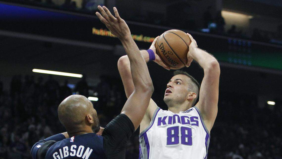 Kings forward Nemanja Bjelica shoots over Minnesota Timberwolves forward Taj Gibson on Friday in Sacramento. Bjelica scored 14 points against his former team and broke out of a shooting slump to help the Kings win 121-110.