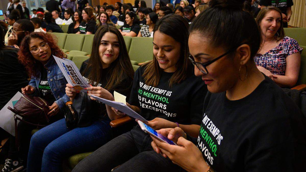 No flavored tobacco products supporters America Rodriquez, Fabiana Calderon, Leslie Cisneros and Christian Rojas wait for the start the meeting at City Hall on Tuesday, April 16, 2019 in Sacramento.