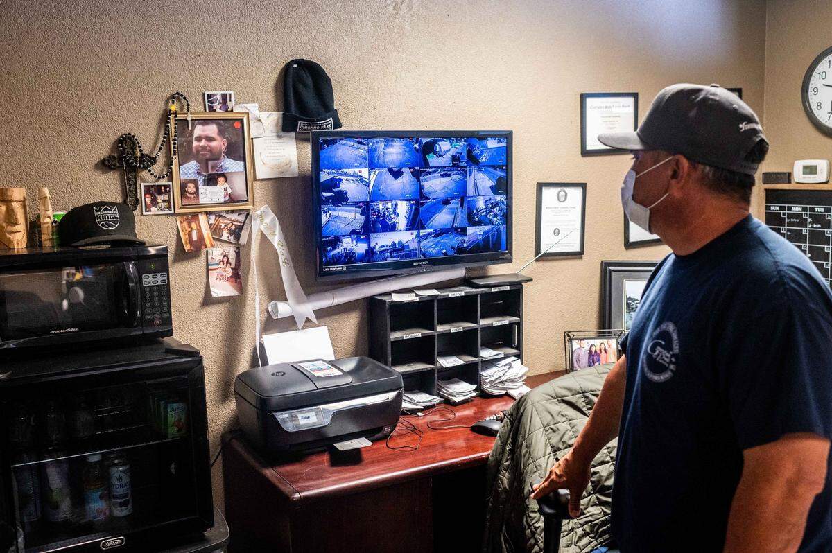 Valentino Rodriguez Sr. looks at a picture of his late son, former correctional officer Valentino Rodriguez Jr., in his office at his West Sacramento business on Tuesday, April 6, 2021. “My son was hazed to death,” said Rodriguez Sr. His family has filed a complaint with the state Department of Corrections and Rehabilitation’s Internal Affairs office alleging harassment.