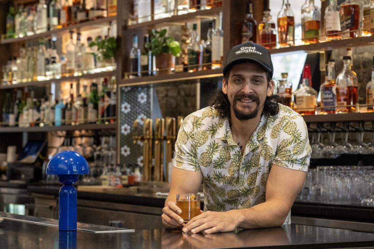 Justin Sheffey, bar director at Good Neighbor, holds a fat-washed old fashioned cocktail on Wednesday, Nov. 19, 2025, in Sacramento.