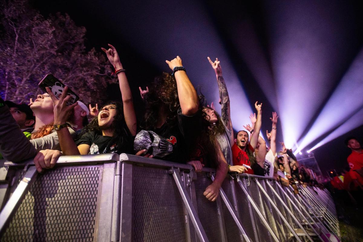 April Guzman Gomez, left, of Stockton, and friends cheer as members of Slipknot perform on the Jack Daniel’s Stage on opening night of the Aftershock rock festival Thursday, Oct. 6, 2022, at Discovery Park in Sacramento. Aftershock runs through the weekend with performances from My Chemical Romance, Papa Roach, Kiss, Danzig and dozens more scheduled to play the three-stage festival.