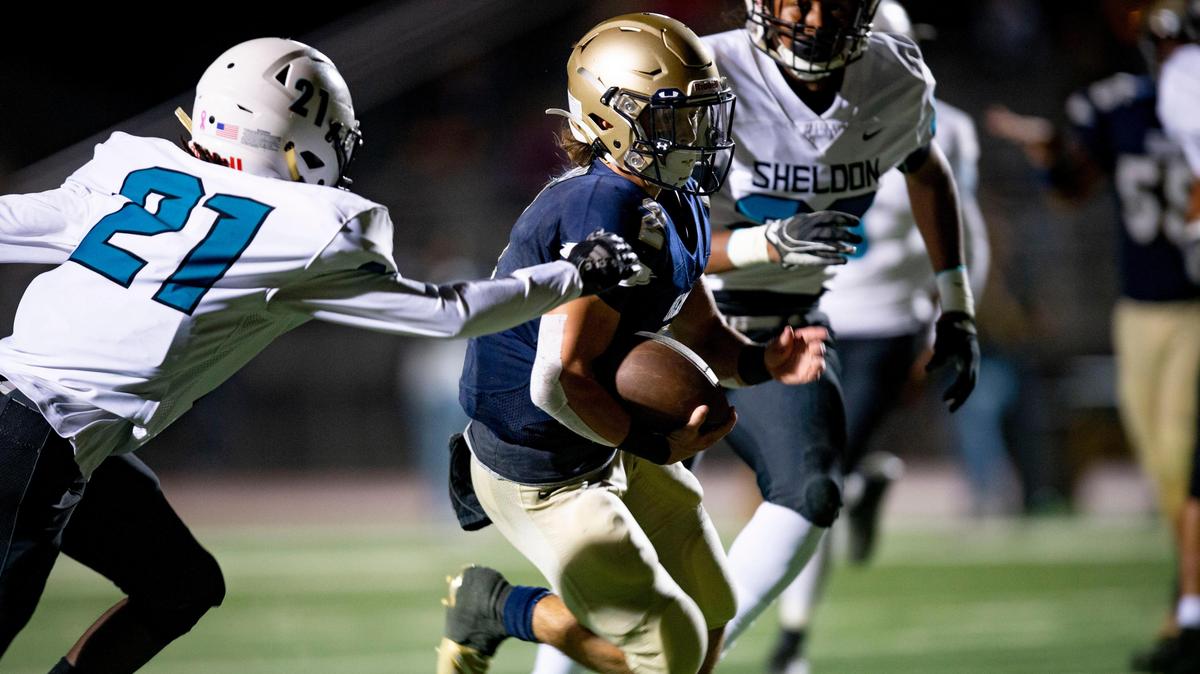 Elk Grove quarterback Carter Harris slips by the Sheldon defense to score a touchdown, Friday, Sept. 27, 2019 at Elk Grove High School.
