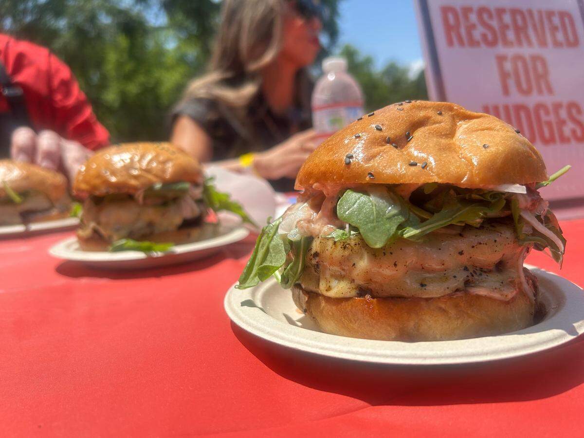 One of the burgers that well-known injury attorney Anh Phoong, who is in the background, and other prominent judges ranked at the American River Parkway Foundation’s burger battle at Discovery Park on Saturday, May 17, 2025.
