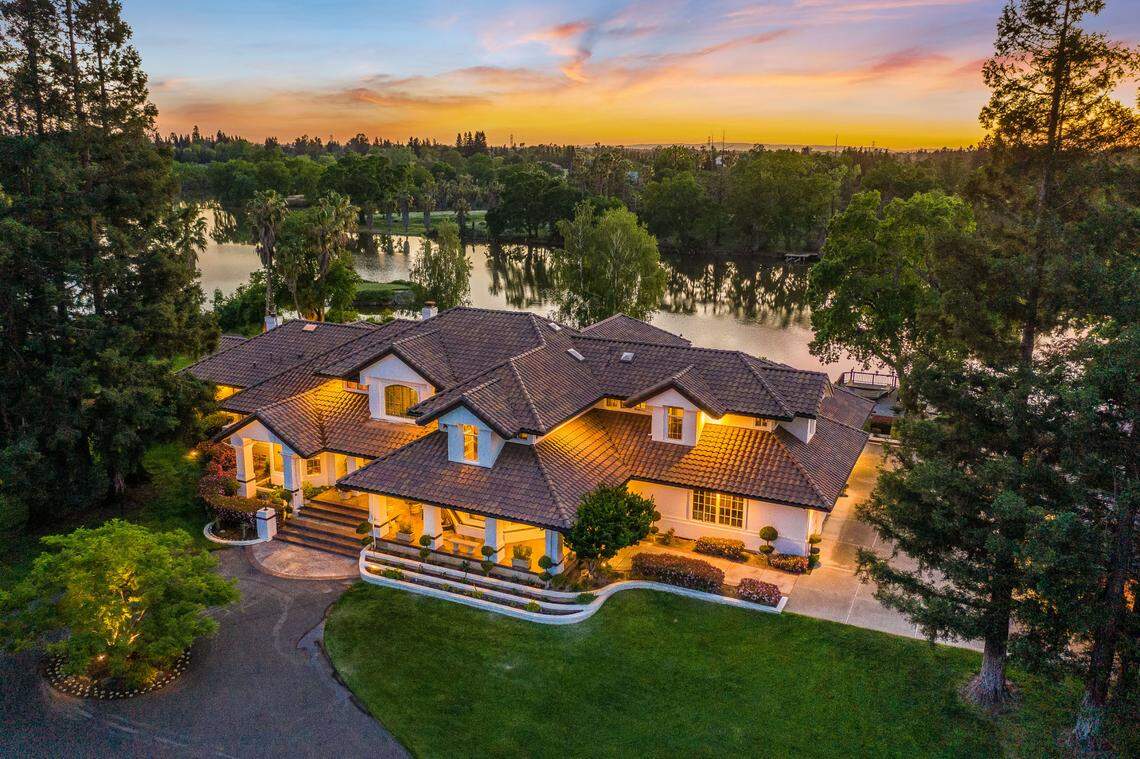 The main home spans 8,900 square feet and overlooks a private lake.