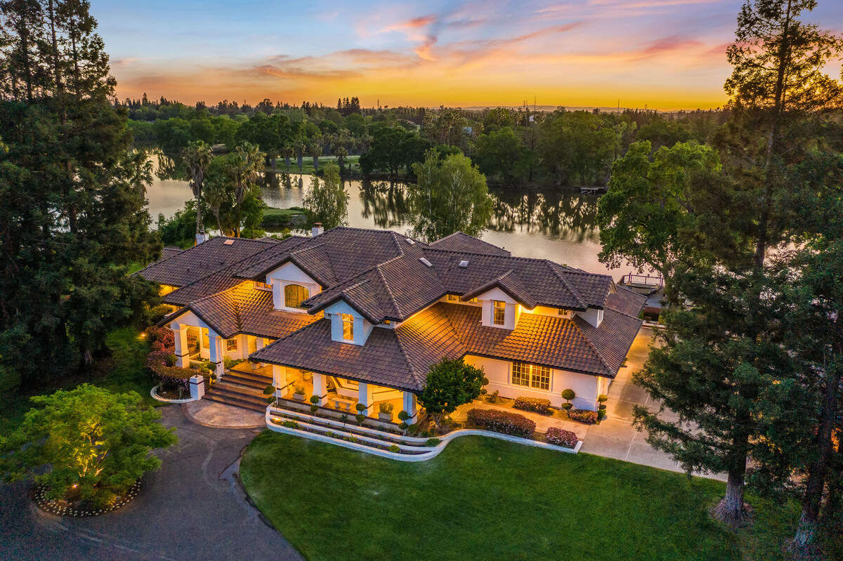 The main home spans 8,900 square feet and overlooks a private lake.