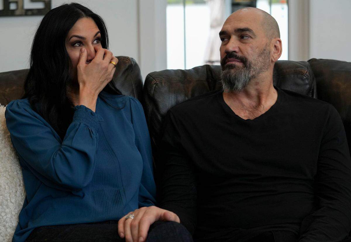 Former Sacramento Kings star Scot Pollard, right, comforts wife Dawn Pollard as they talk at their home in Carmel, Ind., on Dec. 12, 2024, about his heart transplant earlier in the year.