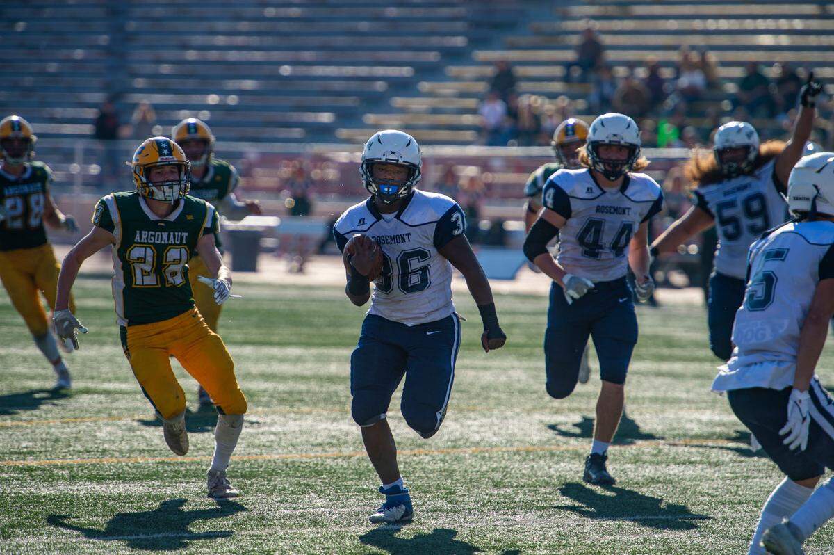 Rosemont Wolverines running back Wayshawn Parker (36) splits the Argonaut Mustangs defense en route to a touchdown to tie the game during the second quarter of the CIF Sac-Joaquin Section Division VI championship game on Saturday, Nov. 27, 2021, at Hughes Stadium in Sacramento. The Mustangs won 31-20.