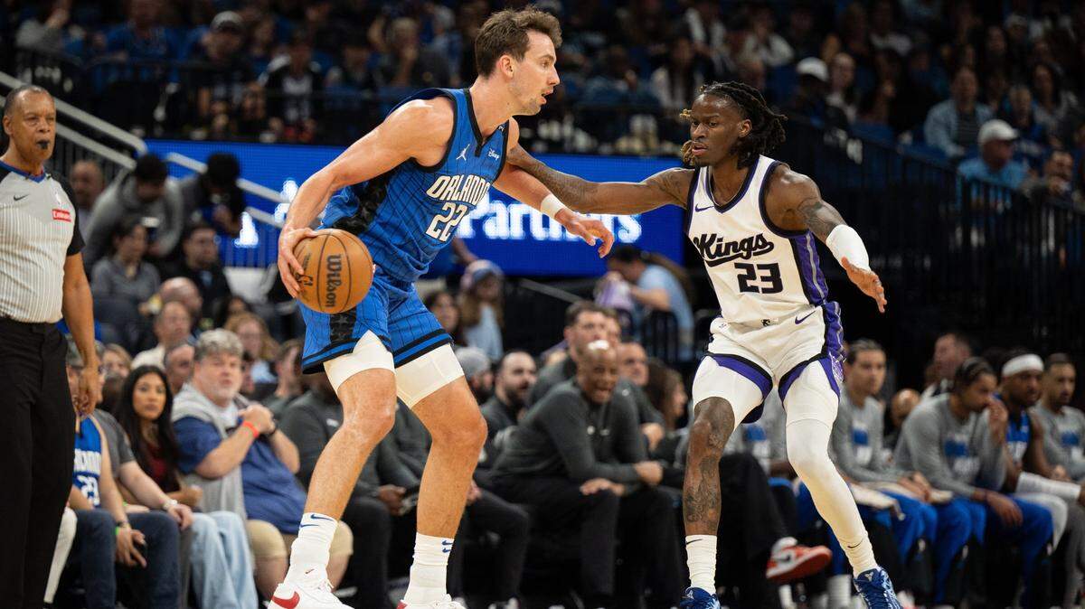 Mar 29, 2025; Orlando, Florida, USA; Orlando Magic forward Franz Wagner (22) dribbles the ball against Sacramento Kings guard Keon Ellis (23) in the first quarter at Kia Center. Mandatory Credit: Jeremy Reper-Imagn Images