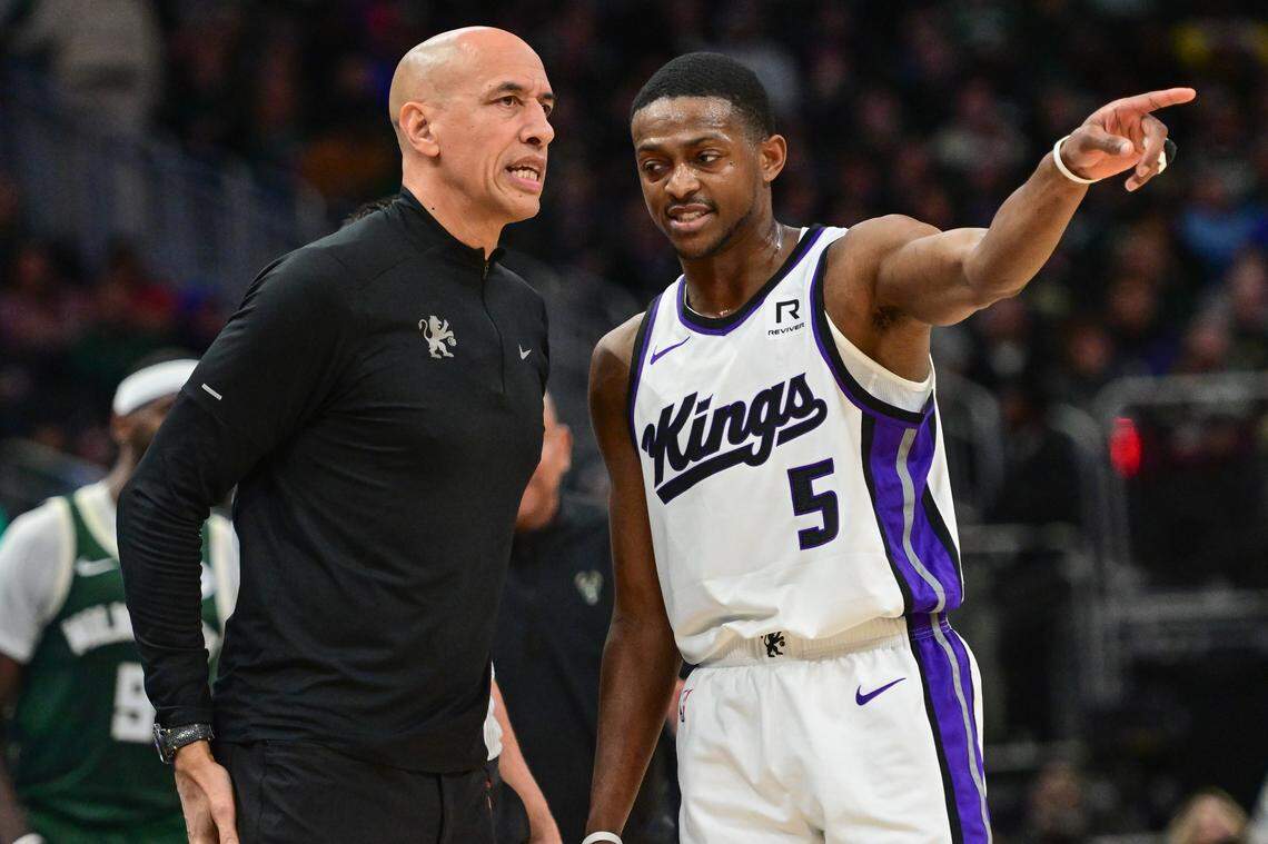 Sacramento Kings guard De’Aaron Fox (5) talks to interim head coach Doug Christie in the second quarter against the Milwaukee Bucks on Jan. 14 at Fiserv Forum in Milwaukee.