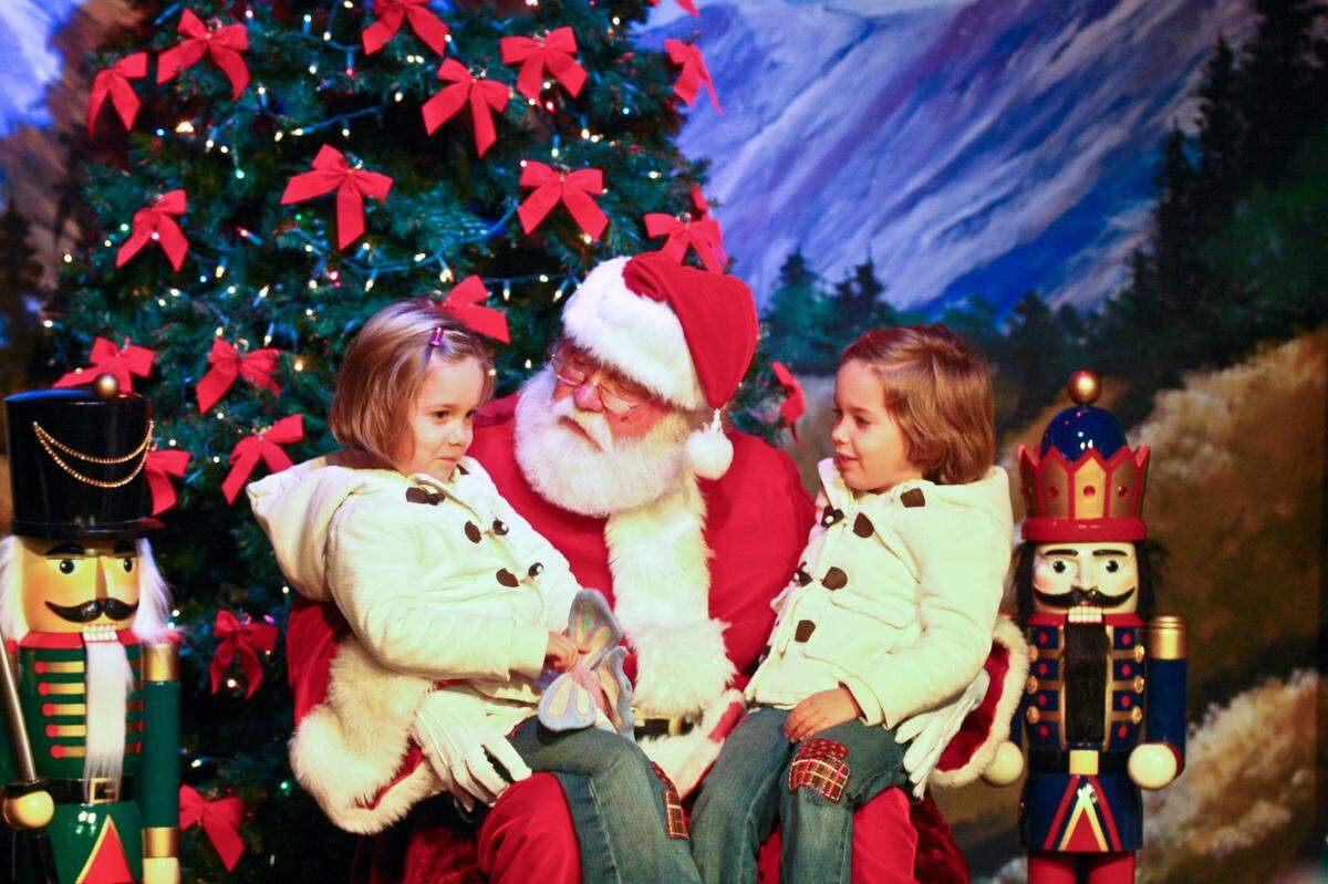 Folsom’s leading railroad historian, Bill Anderson, doubled as Santa Claus in town for 30 years. Here is Anderson in approximately 2015 listening to two girls at a fundraiser in the Sutter Street Theatre.
