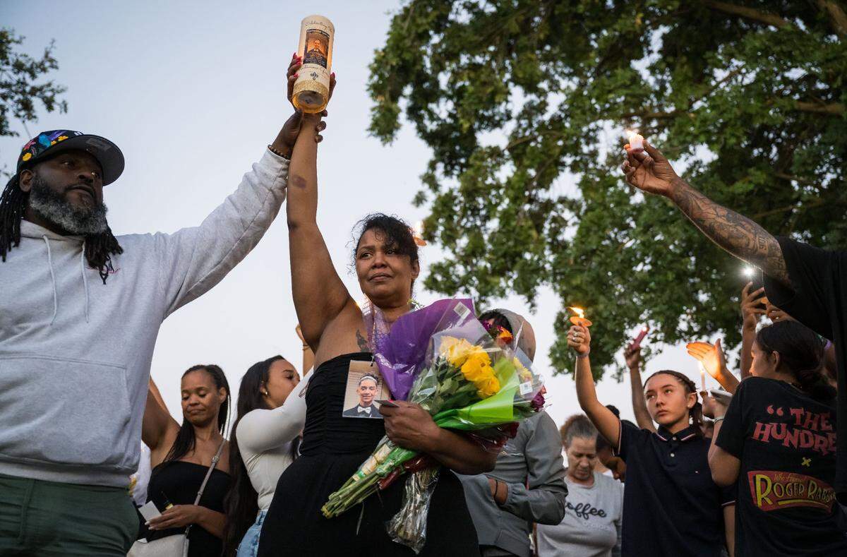 Melody Davis, mother of slain 19-year-old Mactavious Garren, is joined by Sacramento activist and organizer Berry Accius in raising a candle in honor of her son at his vigil on July 6 at Bartholomew Sports Park in Elk Grove. “I’ve seen too many mothers broken like this,” Accius said. “Her baby was loved and her baby’s death will not be forgotten … and it will not be unchallenged,” he added. Garren was killed and his cousin injured July 4 in a shooting at an apartment complex in south Sacramento.