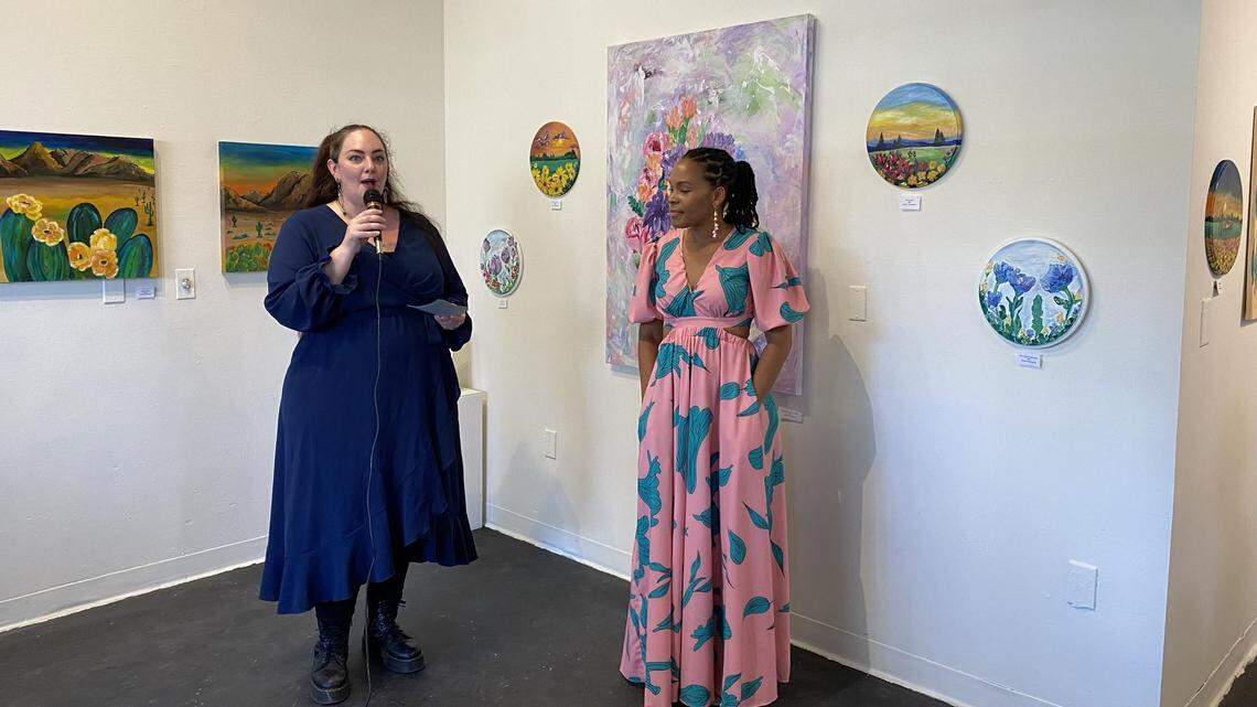 Rhean Goodgame, right, listens while her work is presented at the Atrium 916 at 1020 Front Street in Old Sacramento. Goodgame’s “Island Girl Art” exhibit features ethically sourced and eco-friendly materials.