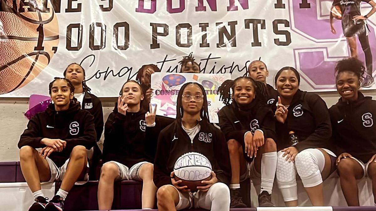 Sacramento High School’s La Ne Dunn, center, scored her 1,000th career point in a game against Del Campo on Jan. 12, 2024. She recently surpassed the school’s all-time career scoring leader, Vicki Baugh, and has 1,526 points as of Monday.