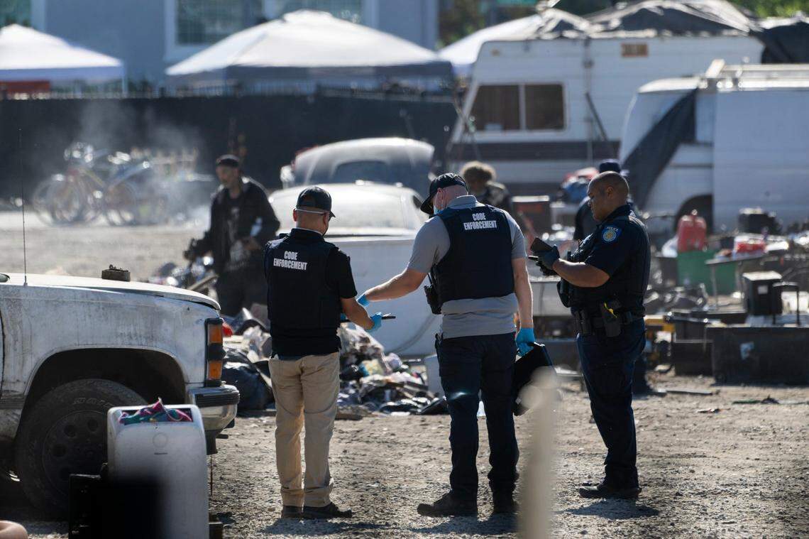 Sacramento Police and code enforcement officers clear out Camp Resolution in August after people living at the self-government North Sacramento homeless encampment refused to leave and barricaded themselves inside.