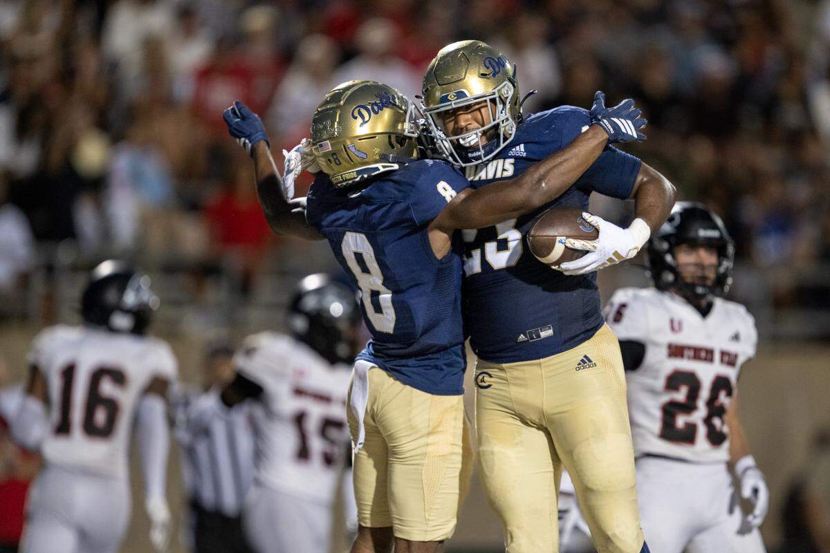 UC Davis Aggies tight end Winston Williams (23) celebrates with teammate Samuel Gbatu, Jr. (8) after scoring touchdown in the first half on Saturday, Sept. 20, in Davis.
