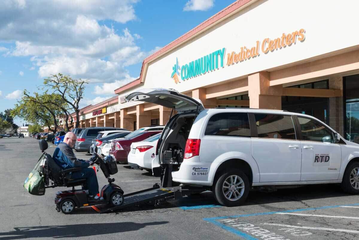 Lloyd Tennison takes his motorized scooter off the van he took to a medical appointment in Stockton.