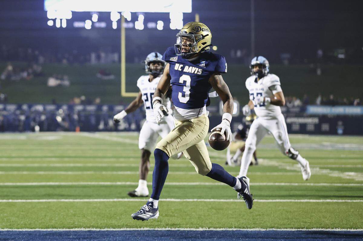 UC Davis Aggies wide receiver Zach Jones (3) scores a touchdown in the second quarter of a second-round NCAA Division FCS playoff game against the Rhode Island Rams at UC Davis Health Stadium on Saturday.