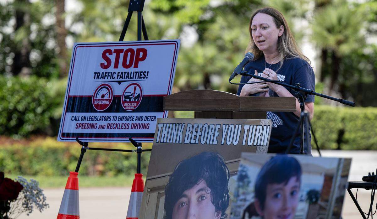 Allison Lyman speaks to a crowd of families and supporters with photographs of her son, Conner Lopez, a victim of vehicular violence, at a memorial rally at the state Capitol on Thursday.